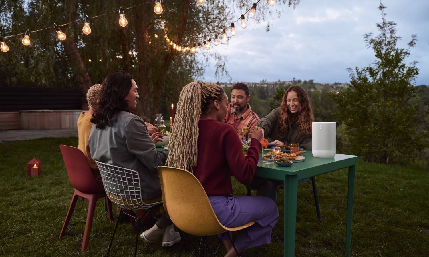 Group of people eating outside while listening to portable sonos speaker